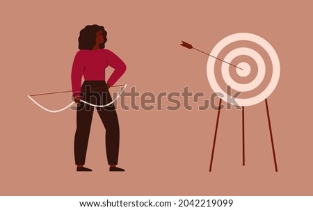 Businesswoman shooting a bow and hit a target. Archery to the bull’s-eye of the dartboard. A strong girl achieves her goals in her life and career. Concept of accuracy business strategy and victory. 