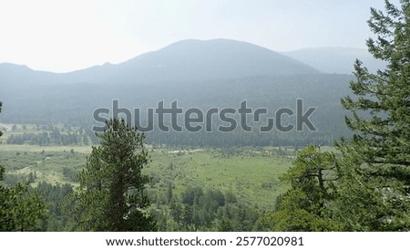 Similar – Foto Bild ein Gebirgszug, umrahmt von Vegetation an den Rändern, an einem Sommertag mit einem Himmel mit baumwollartigen Wolken, Pena Telera, Valle de Tena, Biescas, Huesca, Spanien