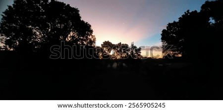 Similar – Image, Stock Photo The night twilight comes. A small glimmer of light from the sun can still be seen.  Lanterns are already on.