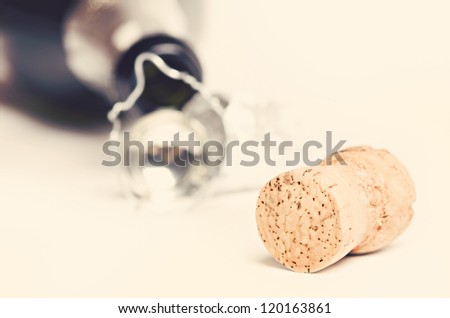 Champagne cork against bottle. Toned image