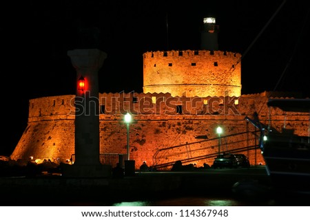 Tower of St. Nicholas in Rhodes (Greece) by night - Bluelight. Motion blur on greek flag and sail masts. Original colors.