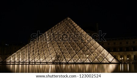 PARIS - MAY 8: Louvre Pyramid at dusk on May 8, 2012 in Paris, France. The Louvre is the biggest Museum in Paris displayed over 60,000 square meters of exhibition space