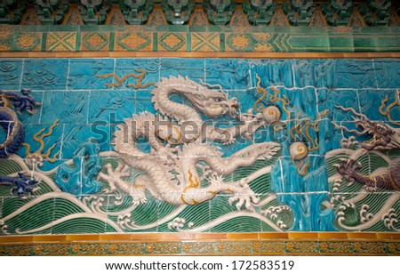 BEIJING, CHINA OCTOBER 13: Dragon sculpture on October 13, 2013 in Beijing, China. The Nine-Dragon Wall (Jiulongbi) at Beihai park, Beijing, China. The wall was built in 1756 CE