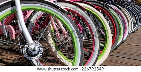 row multicolored bicycle wheels closeup