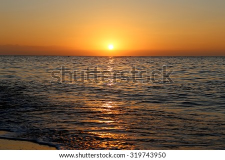 Waves of the sea, illuminated by sunlight at sunset. Costa del Sol (Coast of the Sun), Malaga in Andalusia, Spain