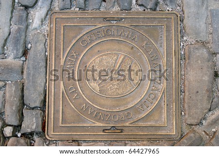 Cover sewer manhole in the street. City artists Groznjan (Grisignana), Croatia, Europe