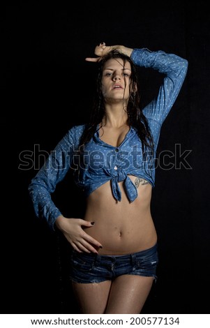 Beautiful wet girl in water on a black background