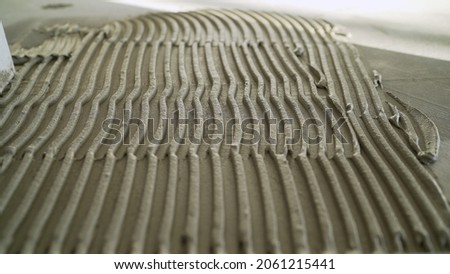 Laying mortar on the floor for ceramic tiles. Ceramic tiles and tools for tiler ceramic tiles installation Home improvement, renovation ceramic tile adhesive, mortar, level. Foto stock © 