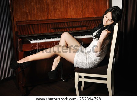 Beautiful young woman at the piano