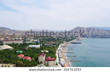 SUDAK, RUSSIA  - SEPTEMBER 27, 2014: Top view of township, shoreline of Sudak Bay and mountain Alchak-Kai