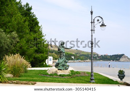 PARTENIT, RUSSIA  - OCTOBER 01, 2014: Paradise (Aivazovsky) park  quay, sculpture of greek sea Lord Poseidon and  view of cape Plaka, Black sea, Crimea