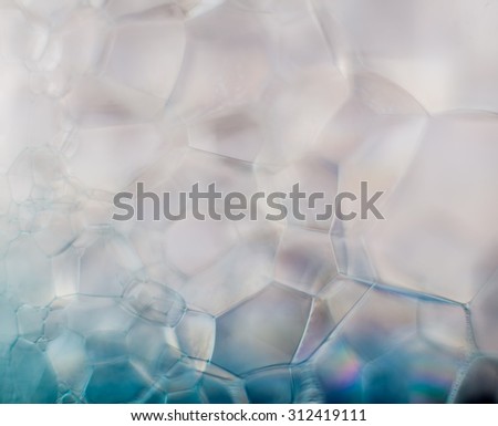 Dreamy hazy abstract background - soap suds macro in blue