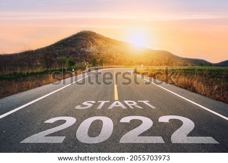 Start 2022 written on highway road in the middle of empty asphalt road of asphalt road at sunset.Concept of planning and challenge, business strategy, opportunity ,hope, new life change.for 2021-2022.