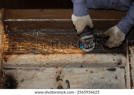 Similar – Image, Stock Photo Industrial worker using angle grinder grinding metal on welding seams. Worker working with angle grinder and has sparks. Tool for cut steel. Safety in industrial workplace. Metal factory industry.