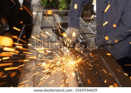 Similar – Image, Stock Photo Industrial worker using angle grinder grinding metal on welding seams. Worker working with angle grinder and has sparks. Tool for cut steel. Safety in industrial workplace. Metal factory industry.