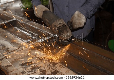 Similar – Image, Stock Photo Industrial worker using angle grinder grinding metal on welding seams. Worker working with angle grinder and has sparks. Tool for cut steel. Safety in industrial workplace. Metal factory industry.