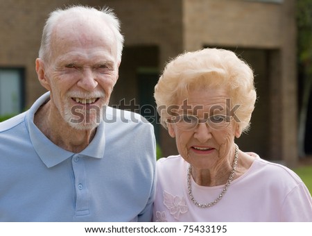 Happy old senior couple outside during the day