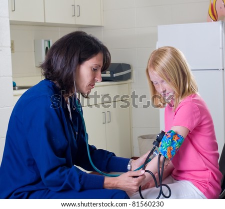 School nurse checking blood pressure of student patient