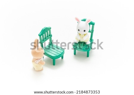 Miniature dollhouse furniture isolated on white background. Rabbit doll. Kids toy. Play and learn. Kids room. Childhood. Kindergarten toy. Developmental toys.  Сток-фото © 