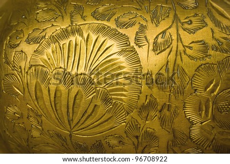 Stamping floral pattern on a metal vase