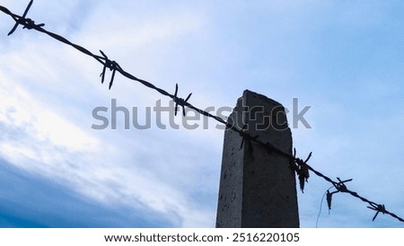 Similar – Image, Stock Photo barbed wire and concrete military fence on the beach near the sea in Crimea