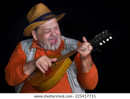 Senior musician with mandolin playing and singing country music on a stage