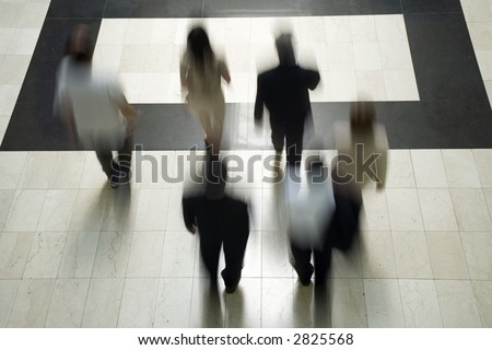 Business people going to work walking through a marble corridor