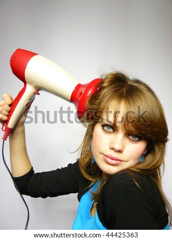 nice girl dries hair the hair dryer