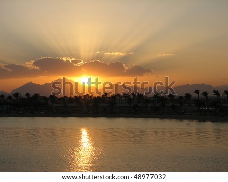 Sunset landscape with the sun reflections in the sea