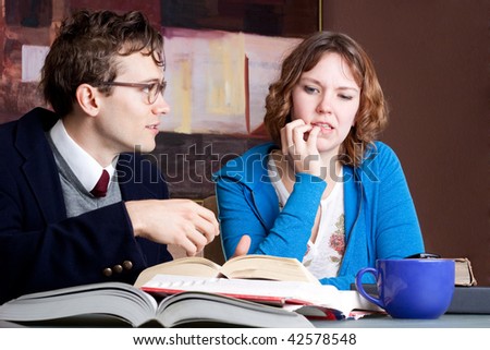 Two students studying, one looking confused