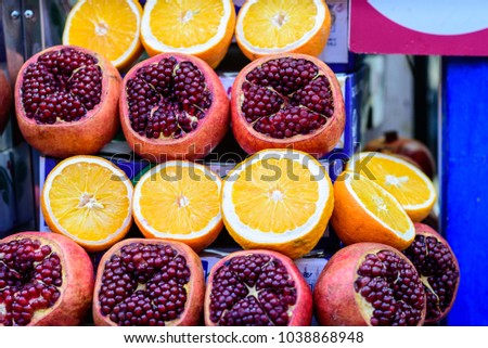 Juicy pomegranates with seed and half fleshy orange. Healthy fruits background. Foto stock © 