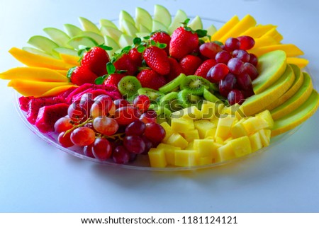 Fruit platter with fresh grapes, apple, pineapple, kiwi, mango, red ripe strawberry and pitaya. Colorful Fruit tray best health good food for party and holidays table. ストックフォト © 