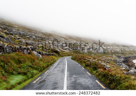 Road disappearing into the mist on the Wild Atlantic Way in Ireland.