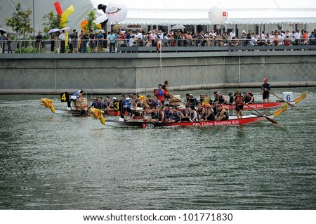 SINGAPORE - MAY 5: Unidentified teams participate in international dragon boat race at Marina Bay, Singapore on May 5, 2012. Close to 100 international dragon boat teams at the DBS Marina Regatta.