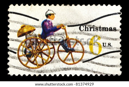 USA - CIRCA 1970 : A stamp printed in the USA shows Christmas 6c (A man on tricycle style bike), circa 1970