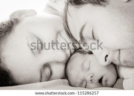 Sleeping baby with mom and dad, closeup faces