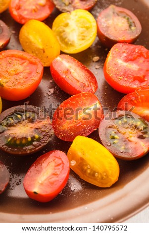Various types of cherry tomatoes on the plate. Tomato salad with sea salt