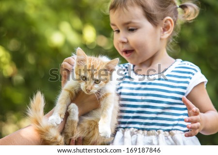 Girl play with kitten