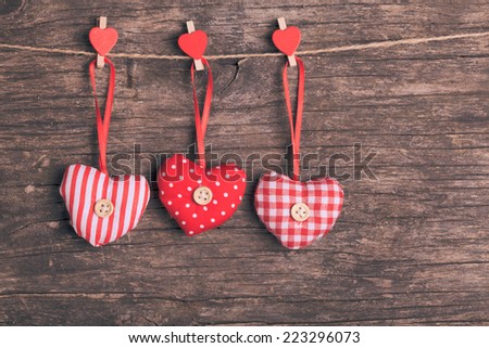 White and red sewed christmas hearts attached to the rope. Holiday background for greetings Valentine\'s  day