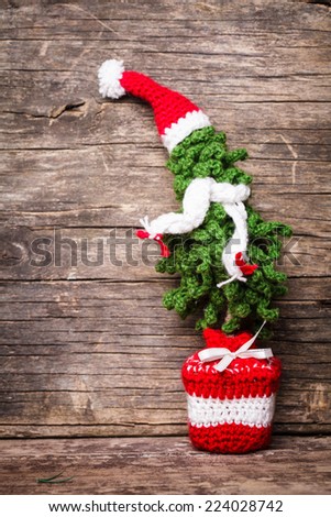 Crochet Christmas tree with scaf and Santa hat, cold winter style