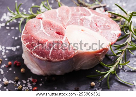 Raw fresh slice of meat - cross cut veal shank on a slate board