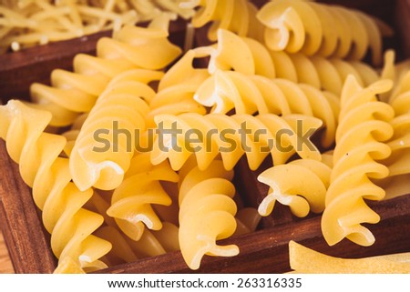 Fusilli pasta  in the wooden box on the table