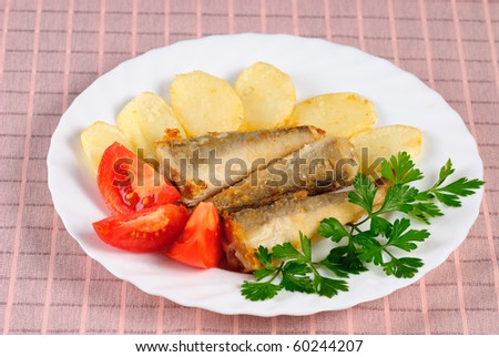 Fried fish and potato dinner on the table