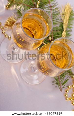two glasses of champagne and gold christmas decorations