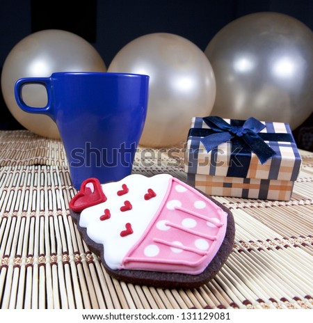 Sweet cup cake cookie, gift box, cup of coffee and balloons