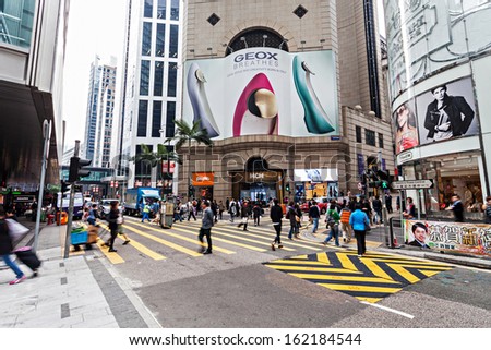 HONG KONG - FEBRUARY 21: Unidentified people crossing the street on February 21, 2013 in Hong Kong. With a 7 million people, Hong Kong is one of the most densely populated areas in the world.