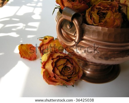 Bright and beautiful Yellow Orange Dry Roses in ethnic brass pot