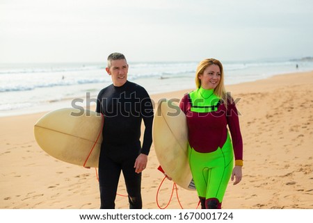 Similar – Image, Stock Photo Content female surfer walking on beach with surfboard