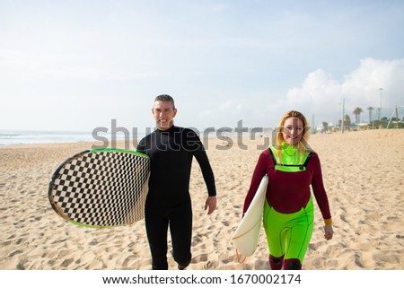 Similar – Image, Stock Photo Content female surfer walking on beach with surfboard