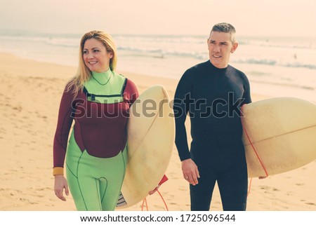 Similar – Image, Stock Photo Content female surfer walking on beach with surfboard